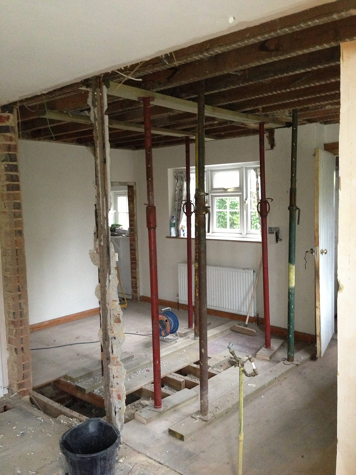 Room opened up with props and a steel beam during structural work